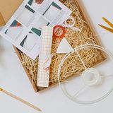 The lampshade kit opened: rings, tape, instructions and a pencil