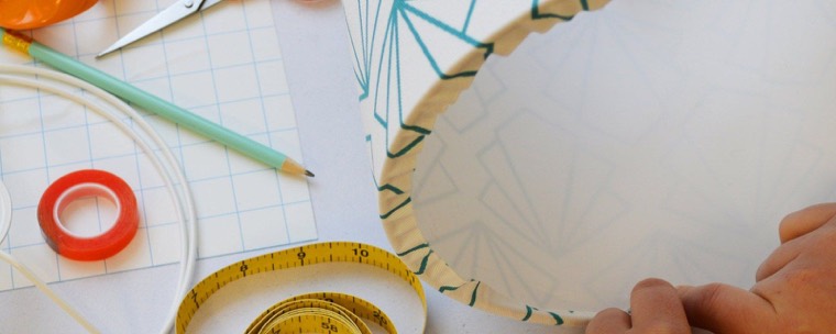 Tucking the printed fabric edge over the ring of a drum shade